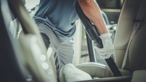 Vacuum cleaner being used on car's interior